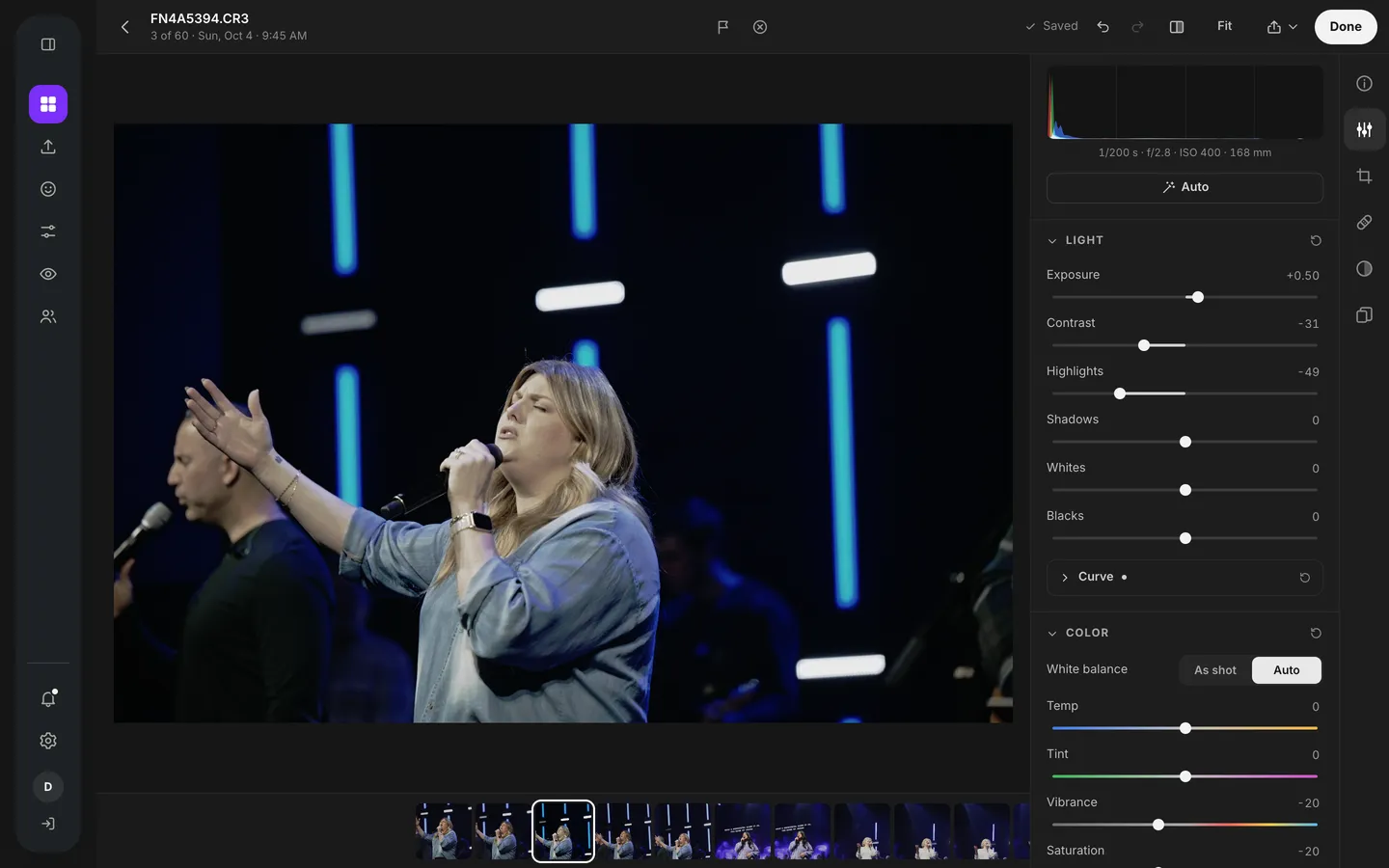 The photo workspace Edit tab: a worship photo next to light and color sliders and a histogram